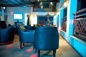 a bar with blue chairs in a room at Hotel Lubumbashi in Lubumbashi