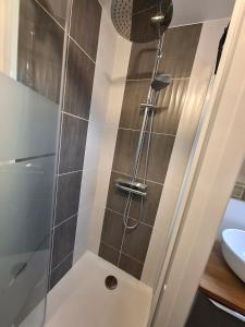 a shower with a glass door in a bathroom at Studio l'écluse in Le Tréport