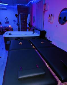 a ping pong table in a room with purple lights at Le relax & vous in La Louvière
