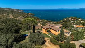 an aerial view of a house on a hill next to the water at Casa Ponente in Porto Santo Stefano