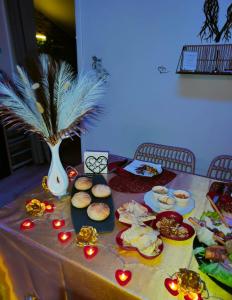 a table with food and a vase with lights on it at Le relax & vous in La Louvière