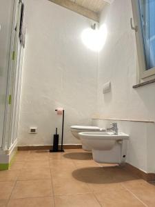 a bathroom with a sink and a toilet at Dimora Farnese in Piacenza