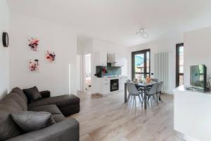 a living room with a couch and a table at Lake Como Retreat Menaggio in Menaggio