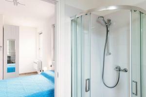 a bathroom with a shower with a glass door at Lake Como Retreat Menaggio in Menaggio +22 photos