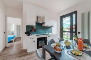 a kitchen and dining room with a table and a dining room at Lake Como Retreat Menaggio in Menaggio