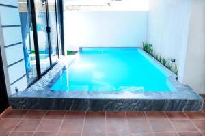 a swimming pool with blue water in a building at Sky Haven in Matara +5 photos