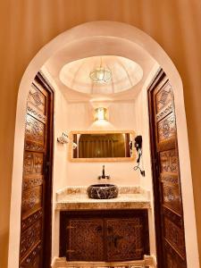 a bathroom with a sink and a mirror at riad tighmart in Merzouga