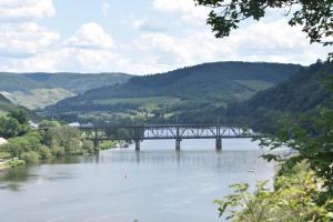 a bridge over a river with mountains in the background at Mosel-Refugium Nr 5 in Zell an der Mosel