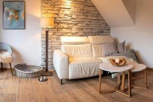 a living room with a couch and a table at Modern Birch Chalet At Ruppberg in Zella-Mehlis +16 photos