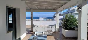 a balcony with a view of the ocean at Midiè Savelletri in Savelletri di Fasano