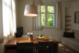 a living room with a table with a bowl of fruit on it at Ceccarini Suite in Riccione