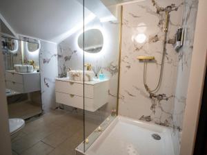 a bathroom with a shower and a tub and a sink at Love Room Serenity Suite in Montbéliard