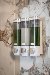 a group of four glass containers on a wall at Love Room Serenity Suite in Montbéliard +16 photos