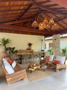 a living room with benches and a table and lights at Vilarejo Ibitipoca in Conceição da Ibitipoca