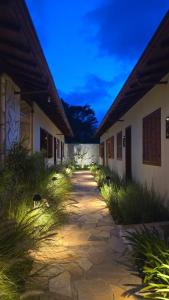 a walkway between two buildings with a sky at Vilarejo Ibitipoca in Conceição da Ibitipoca +15 photos