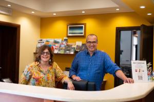a man and a woman standing at a counter at Villa Delle Ciliegie in Deiva Marina