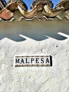 a sign that says malibu on the side of a building at Malpesa Rural in Poveda de la Obispalía