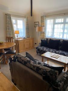 a living room with a couch and a table at The Bothy in Lyndhurst