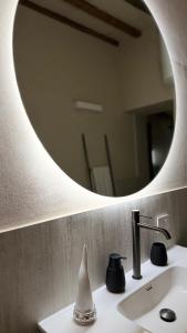 a bathroom with a mirror and a white sink at Porto 24 in Portoferraio +17 photos