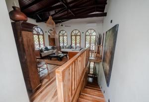 an open living room with a staircase and a living room at Tara Luxury House in Habaraduwa Central
