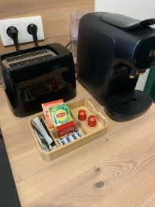 a coffee maker and a toaster on a table at Le Studio Vert in La Flèche