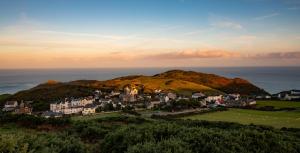 a group of houses on a hill near the ocean at The Smugglers Rest in Woolacombe