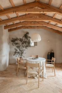 a dining room with a table and chairs and a ceiling at Hotel Vestige Binidufà in Isla de Menorca +38 photos
