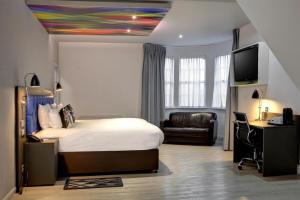 a bedroom with a bed and a desk and a tv at Best Western Plus Nottingham Westminster Hotel in Nottingham