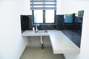 a kitchen with a sink and a window at Sky Haven in Matara