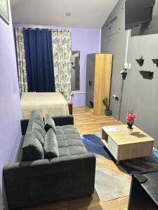 a living room with a couch and a bed at Cozy Nest & Car rental in Scarborough