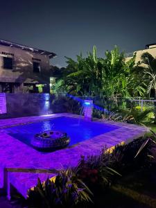 a swimming pool with purple lighting at night at Cozy Nest & Car rental in Scarborough