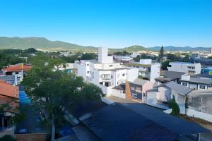 a view of a city with white buildings at Curta Praia do Quilombo - Palladium in Penha
