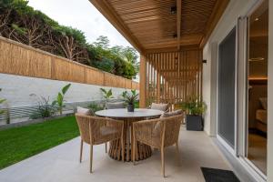 an outdoor patio with a table and chairs at Nadia Suites Residencess Adults Only in Malia