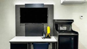 a room with a desk with a microwave and a tv at Motel 6-Atascadero, CA in Atascadero