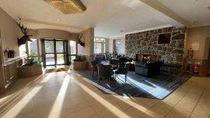 a large living room with a stone wall at Cabarfeidh Hotel in Stornoway