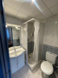 a bathroom with a shower and a toilet and a sink at Hôtel & Résidence Avermes in Avermes +15 photos
