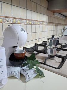 a kitchen counter with a mixer on a stove at Sciara casa vacanze in Viagrande