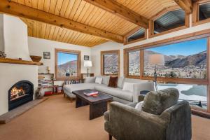 a living room with a couch and a fireplace at Shadow Mountain 10 in Aspen +41 photos