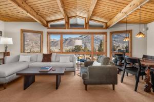 a living room with a couch and a table at Shadow Mountain 10 in Aspen