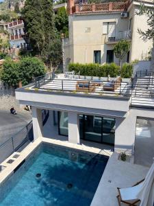an external view of a house with a swimming pool at Villa Ada in Taormina