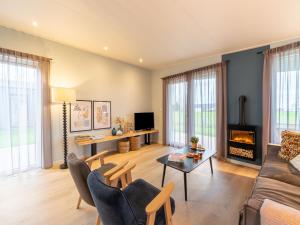 a living room with a couch and a fireplace at Bij de Bakker in Oud-Ade