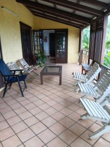 a patio with lounge chairs and a coffee table at Acacia Retreat in Île La Fond