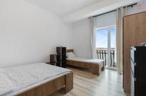 a bedroom with a bed and a large window at Apartament 2 dormitoare spatios, Aer conditionat, Flat Screen TV, Self Check-in in Ştefăneştii de Sus