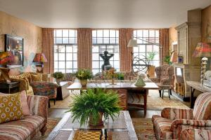 a living room with couches and a table at The Soho Hotel, Firmdale Hotels in London