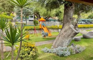 a playground with a slide in a park at Villaggio Turistico La Fenosa in Marina di Camerota