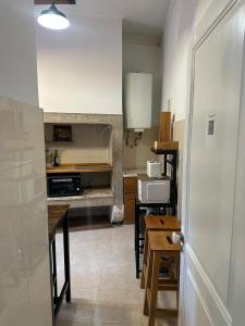 a kitchen with a table and some chairs and a counter at Sintra Flower Camelia Apartment in Sintra