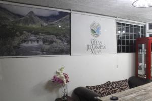 a wall with a sign on it with a couch at Villas Tecuanapan in Xalapa