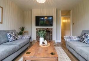 a living room with two couches and a coffee table at High Tide in Whitstable