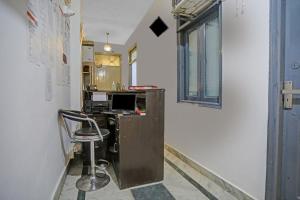 an office with a desk and a chair in a room at Hotel O The Premium Villa in New Delhi