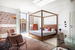 a bedroom with a canopy bed and a glass table at Palazzo Sovrana Serviced Luxury Apartments in Palermo